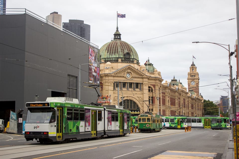 A photo of Flinders Street Station with B2 class, W8 class and Z3 class trams in front on Flinders St and Swanston St.