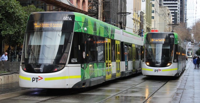 Two E class trams on Bourke Street Mall on a rainy day in Melbourne