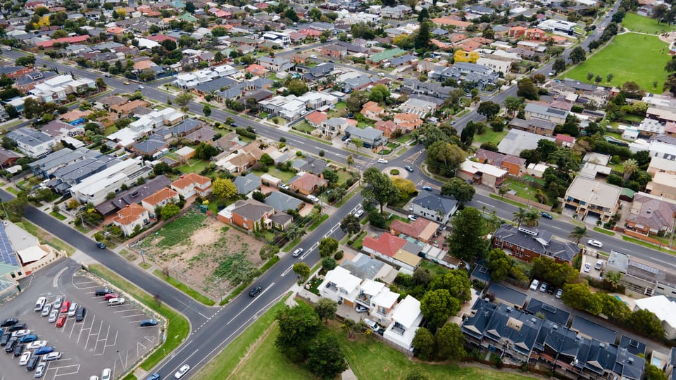 Aerial photo of a typical suburb with houses, roads and trees in Melbourne