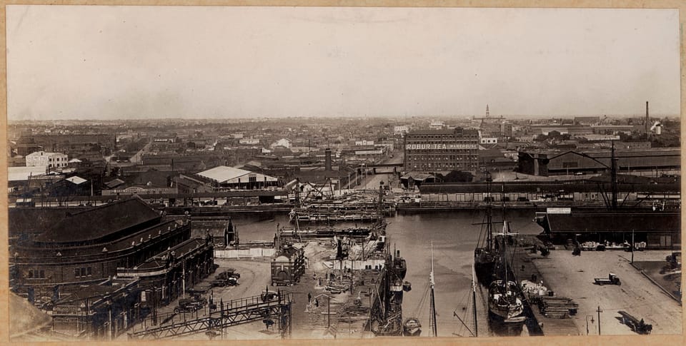 Black and white photo of a bridge under construction viewed from the top of a building in Melbourne, Australia