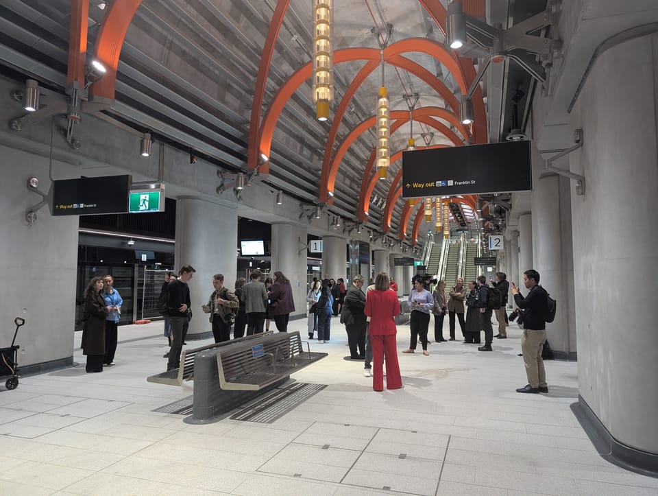 Photo of people standing on platforms in the new underground State Library Station
