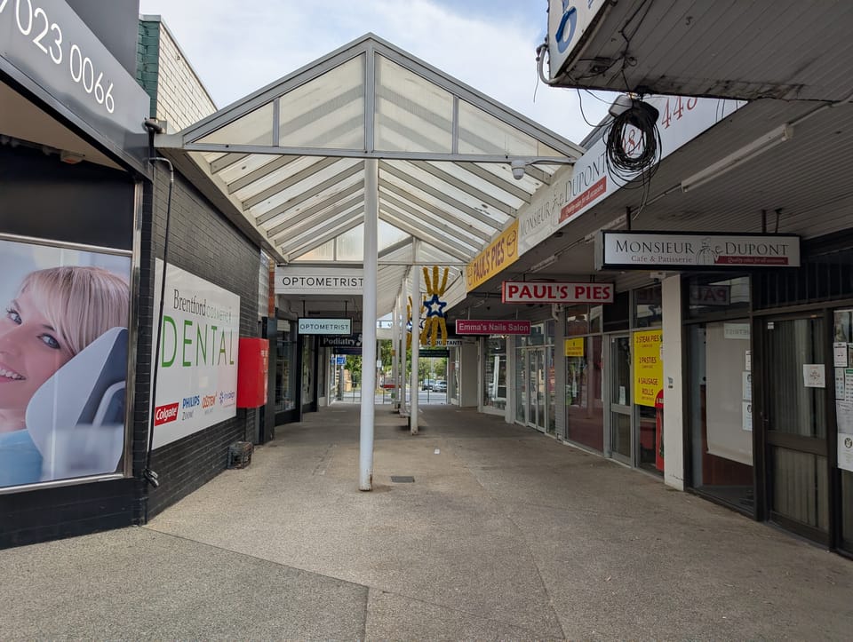 Photo of a triangular canopy over the pedestrian walkway on the south side of Brentford Square Shopping Centre.
