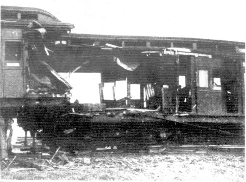 Black and white photo of a destroyed Tait train with another crashed into it.