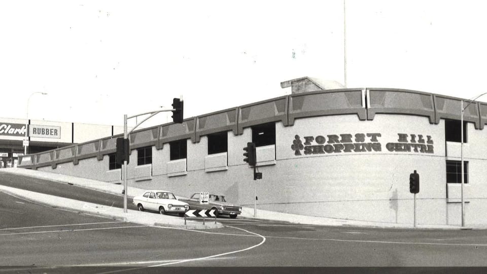 Black and white photo of the front of the new carpark with a sign saying "Forest Hill Shopping Centre"