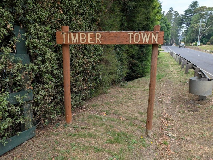 Photo of a wooden sign at the entrance to Powelltown saying "Timber Town".