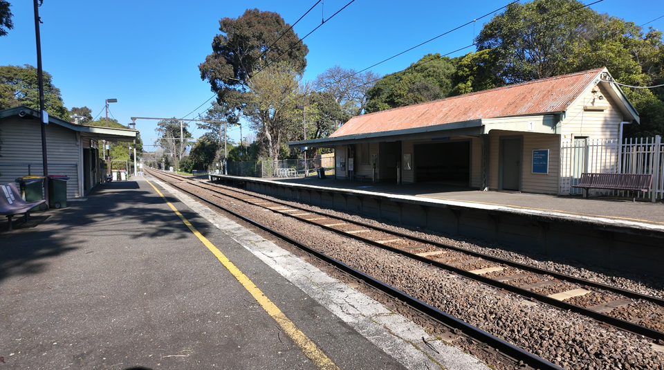 A photo of Willison Railway Station looking along the tracks and its old building